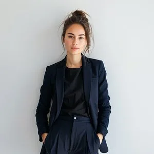 woman-wearing-black-suit-stands-front-white-wall_resultJPG2